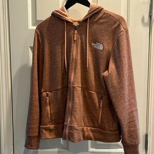 The North Face Pink/salmon color zip-up hoodie with ultra soft fleece lining.